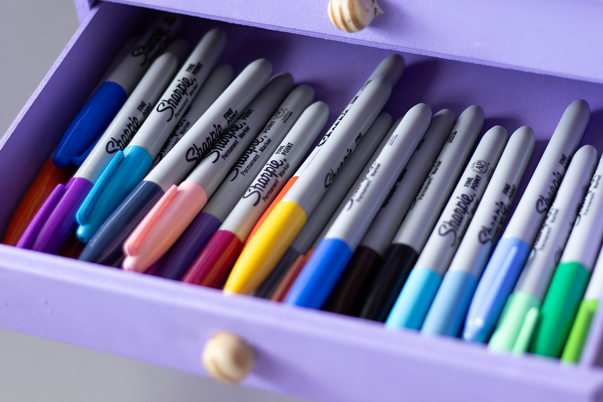 A lilac drawer with Sharpie pens inside.