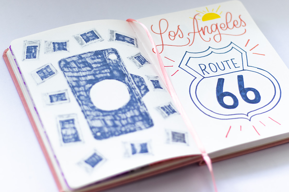 A sketchbook with a drawing that reads "Los Angeles" and "Route 66"